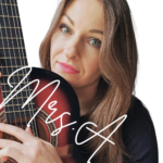 Mrs.A - music teacher, holding a guitar